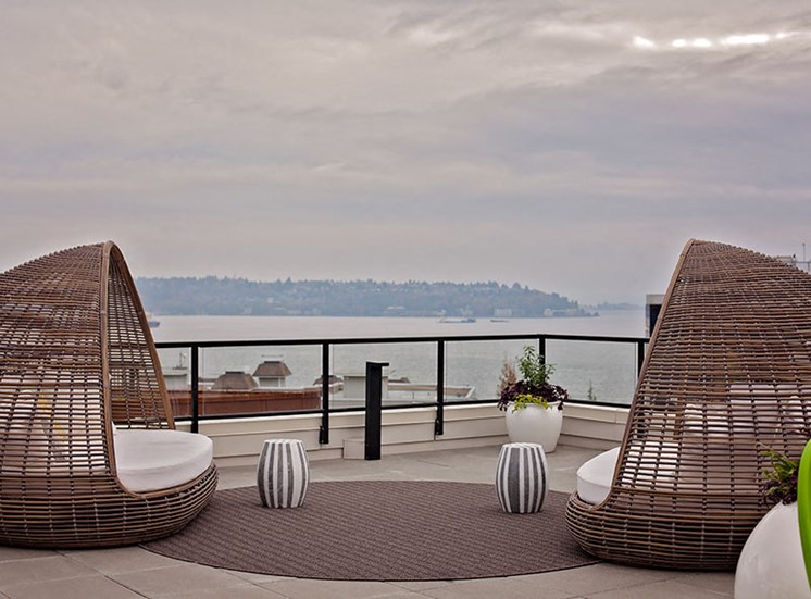 Rooftop Deck With Outdoor Seating At Clarendon Apartments in Seattle, WA